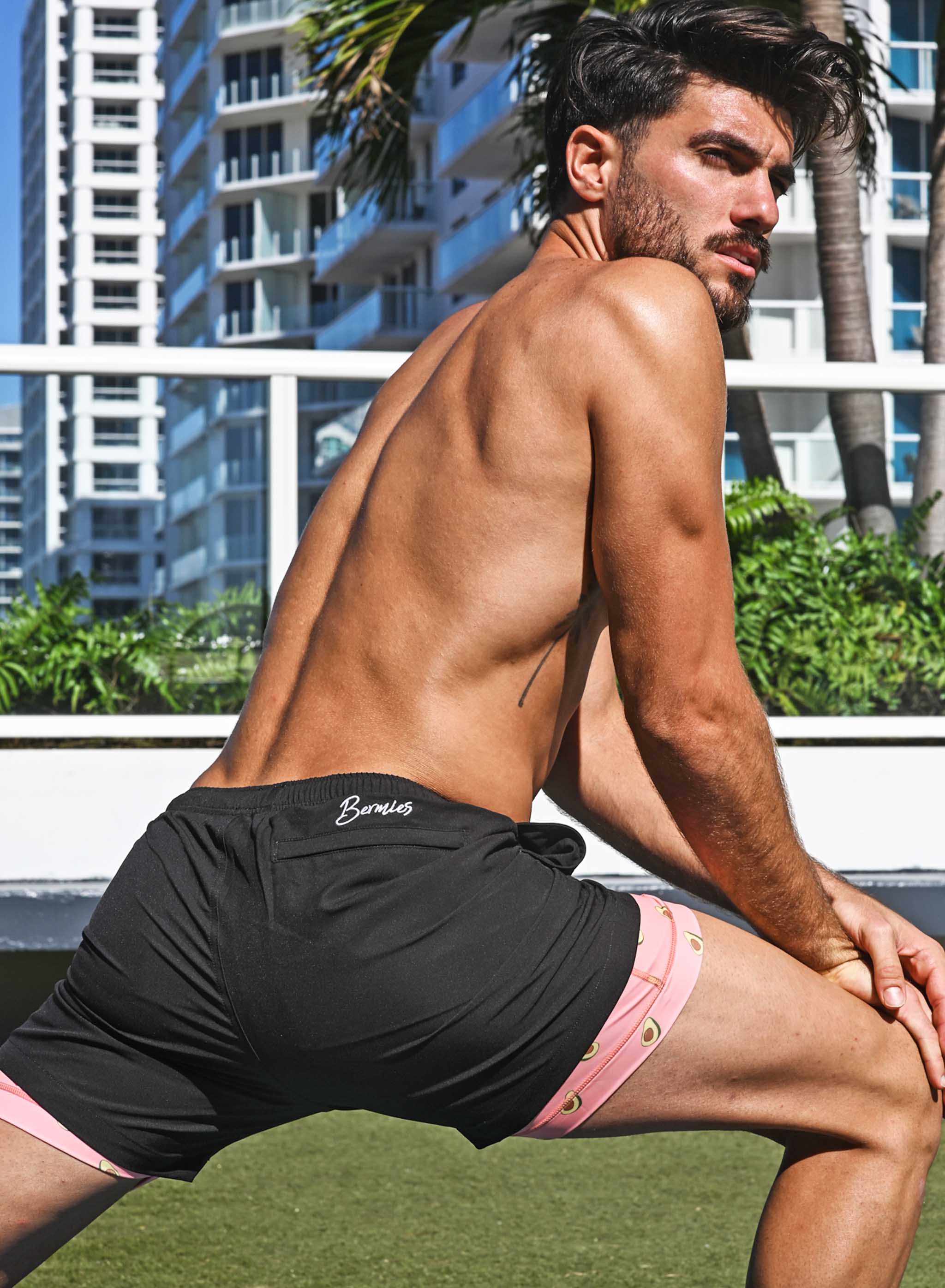 Black Avocado performance shorts featuring a compression liner and pockets, designed for training and workouts.