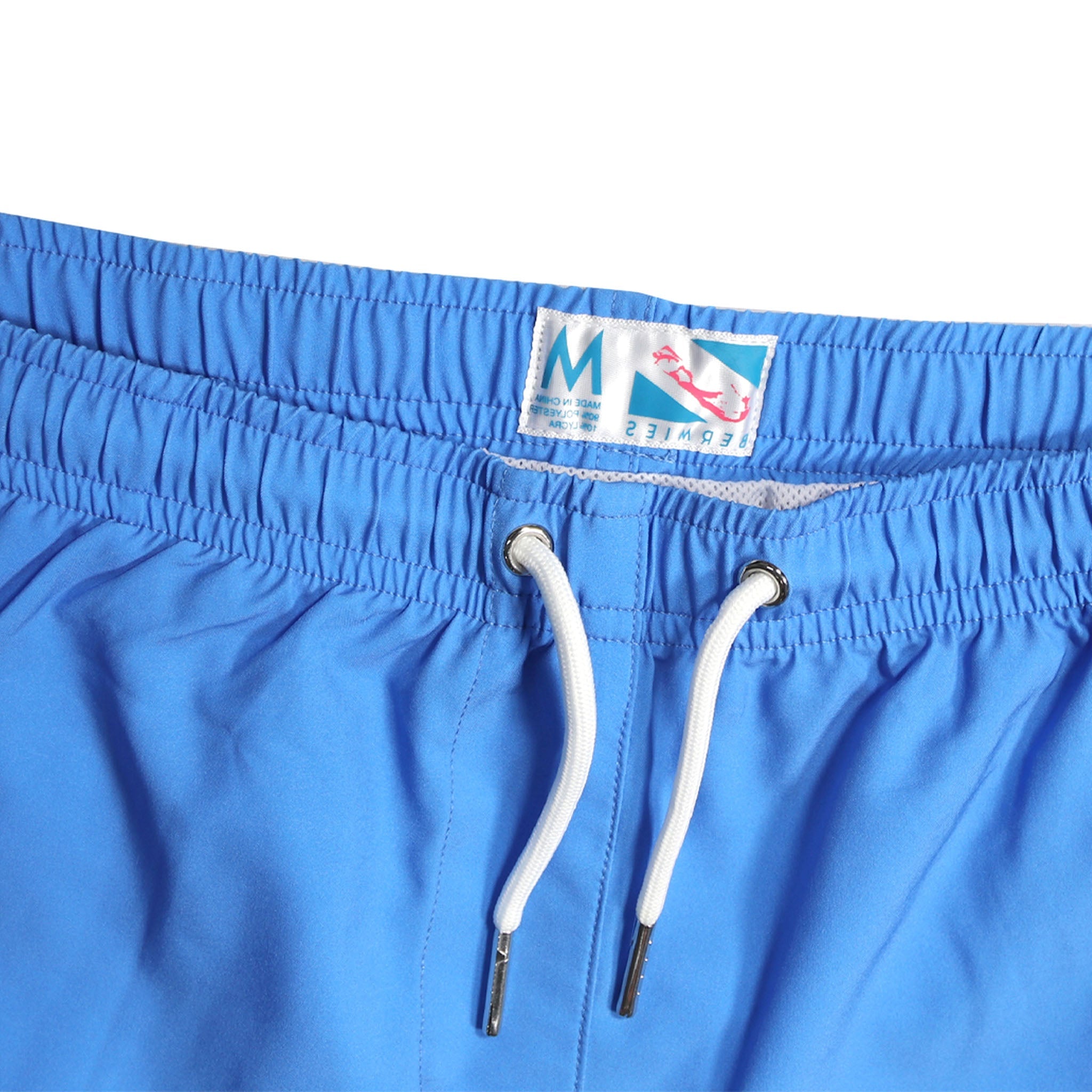 Blue swim trunks with green pocket, featuring a stylish design and eco-friendly materials.