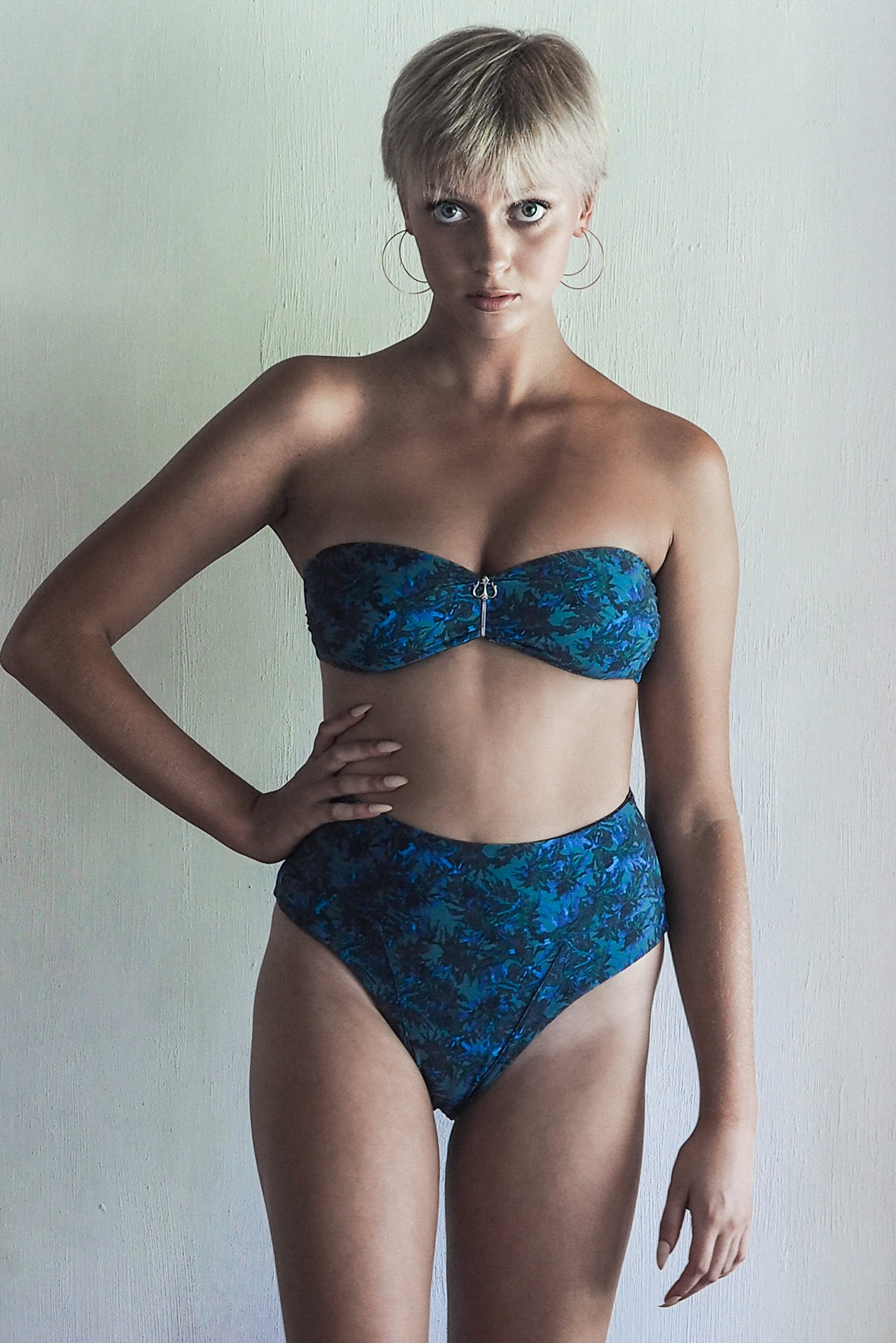 DONITA BOTTOM in SEA JUNGLE featuring high-waisted design with intricate blue and green foliage print on a khaki base.