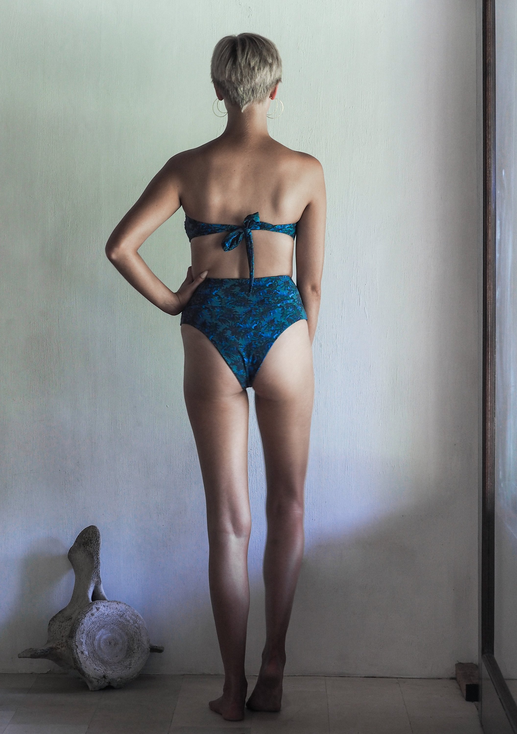 DONITA BOTTOM in SEA JUNGLE featuring high-waisted design with intricate blue and green foliage print on a khaki base.