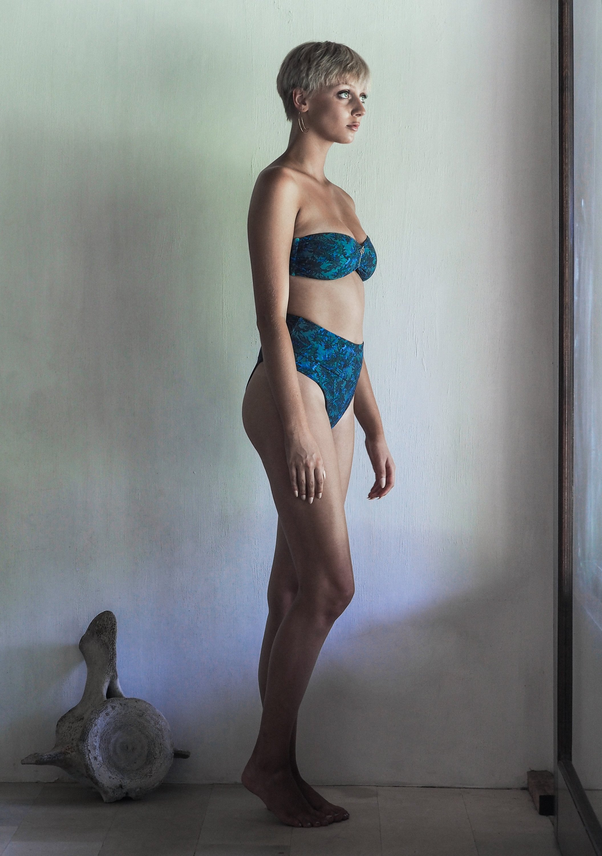 DONITA BOTTOM in SEA JUNGLE featuring high-waisted design with intricate blue and green foliage print on a khaki base.