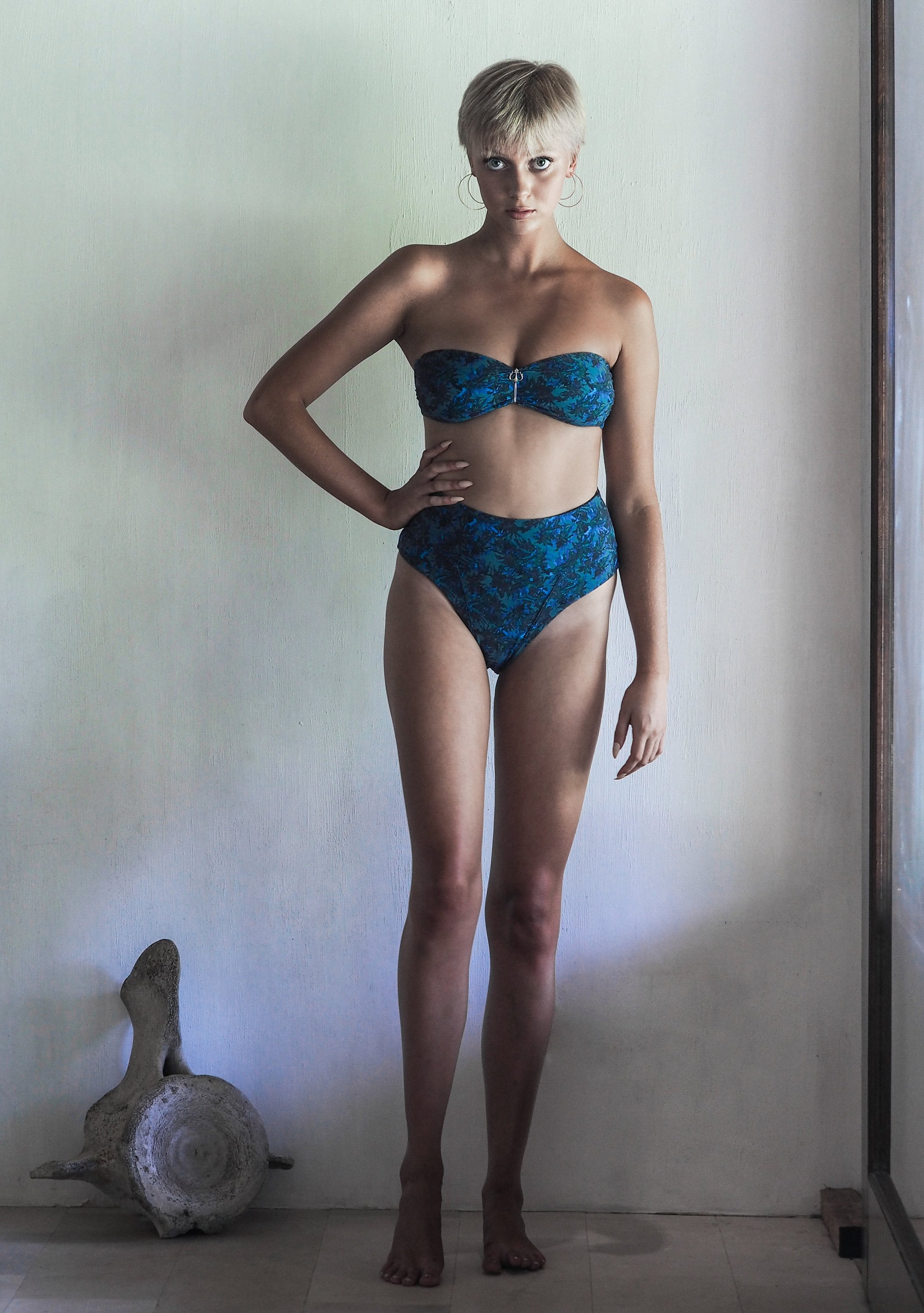 DONITA BOTTOM in SEA JUNGLE featuring high-waisted design with intricate blue and green foliage print on a khaki base.