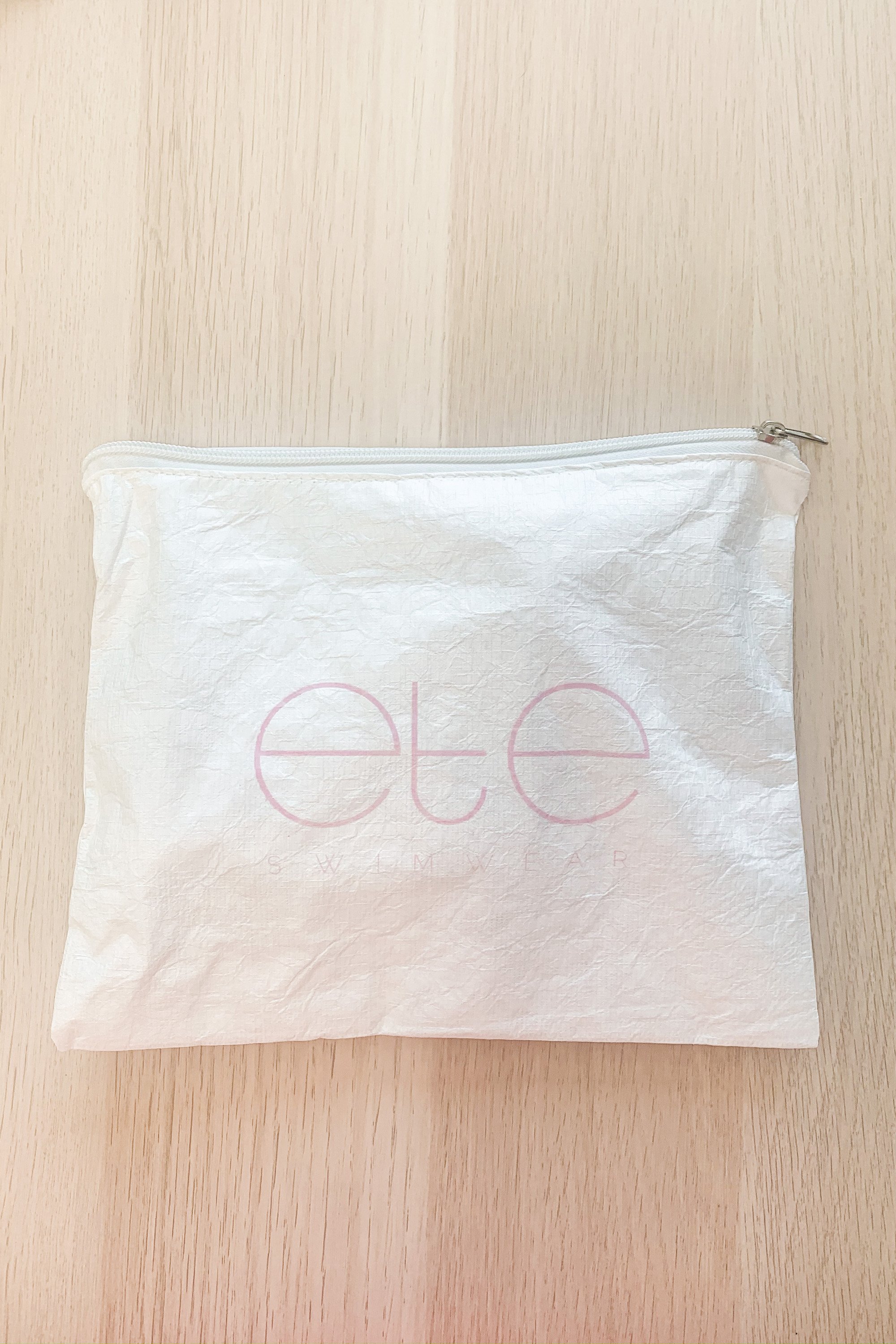 Ete Swimwear Splash-Proof Beach Bag in light pink, showcasing its stylish design and zip closure.