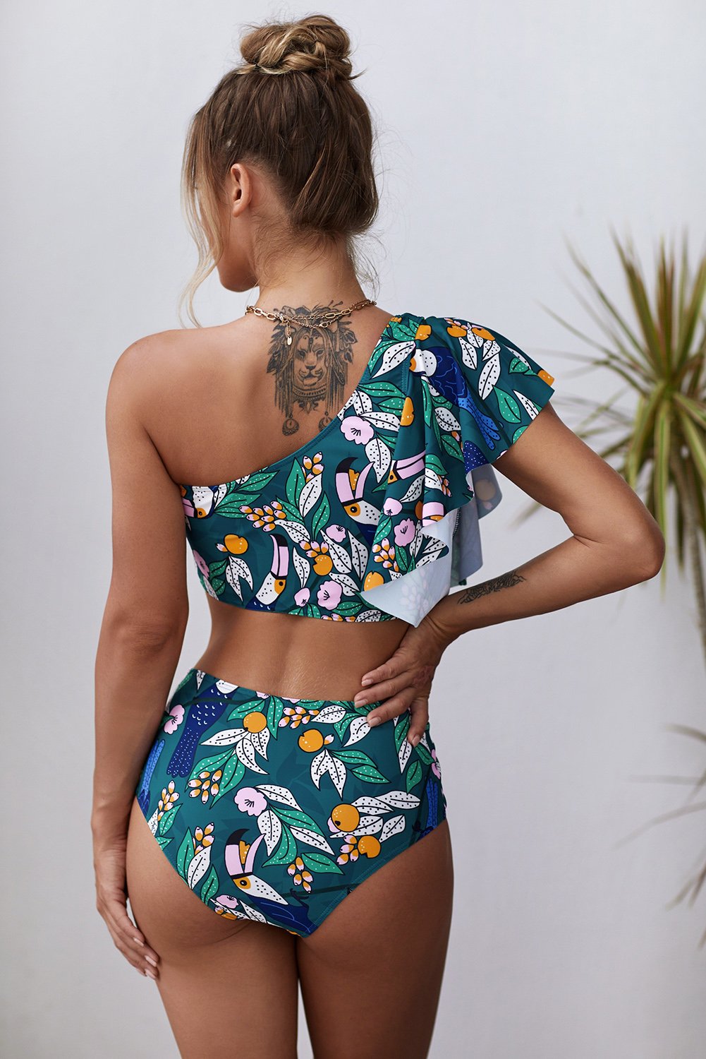 Green floral print ruffled single shoulder high waist swimsuit, showcasing stylish design and vibrant colors, perfect for summer beach activities.