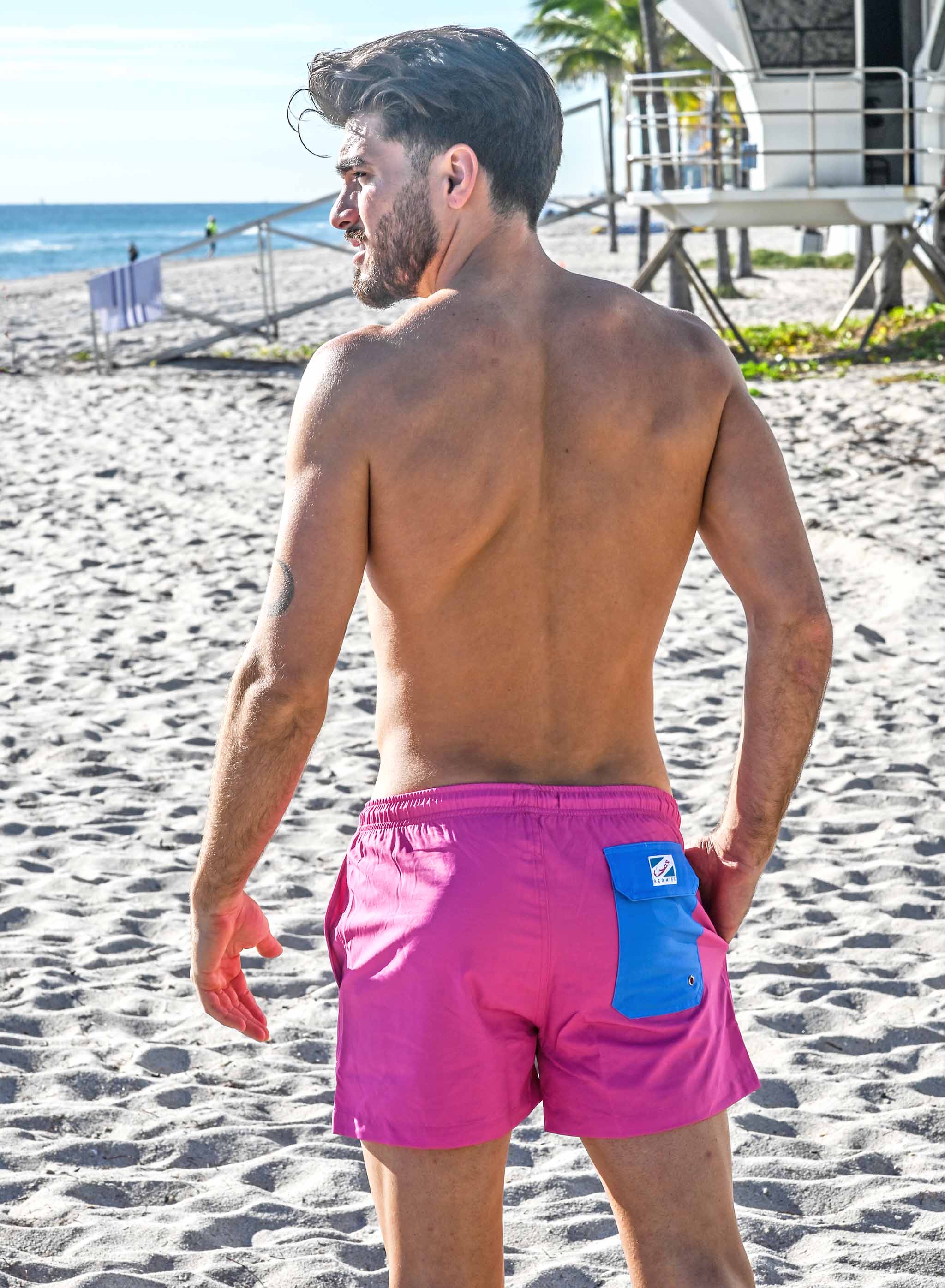 Magenta blue swim trunks with pockets and elastic key loop, designed for comfort and style.