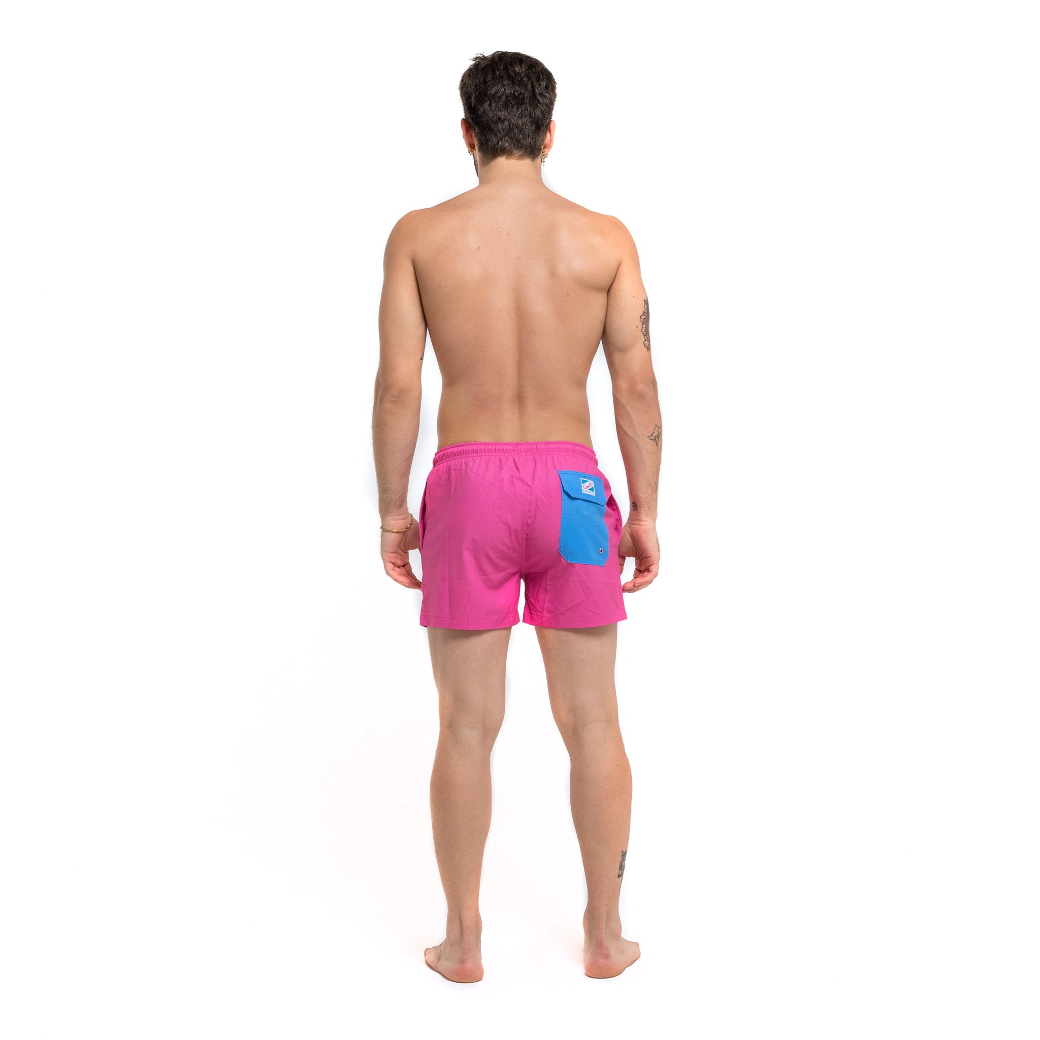 Magenta blue swim trunks with pockets and elastic key loop, designed for comfort and style.