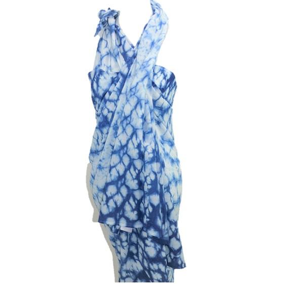 A beautiful Mystic Ocean Indigo Scarf showcasing unique tie-dye patterns in varying shades of indigo, handcrafted from soft cotton fabric.