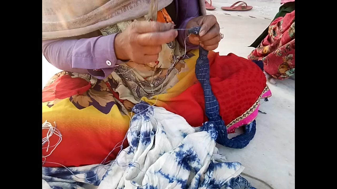 A beautiful Mystic Ocean Indigo Scarf showcasing unique tie-dye patterns in varying shades of indigo, handcrafted from soft cotton fabric.