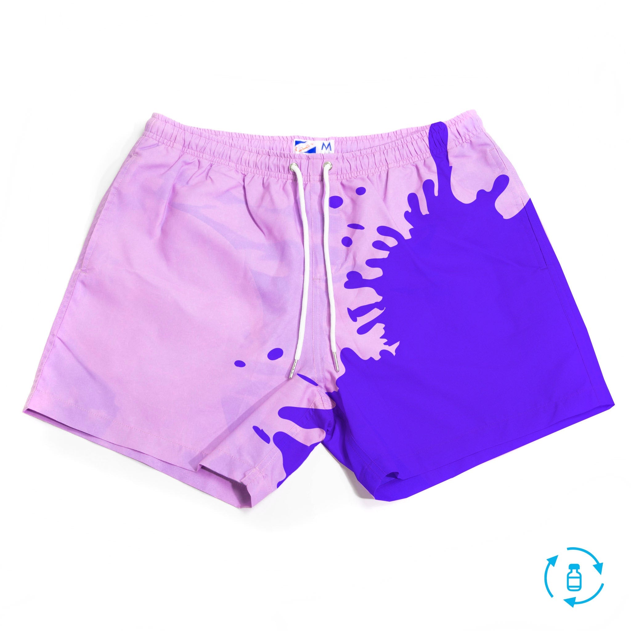 Color-changing Pink to Purple 5" Swim Trunks displayed on a beach setting, showcasing their vibrant colors and eco-friendly design.