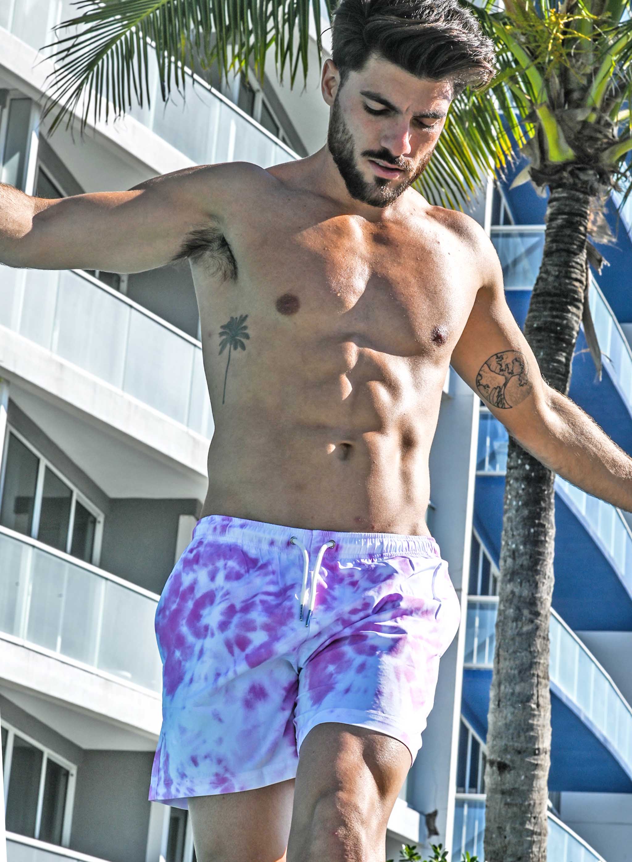 Purple Tie Dye 5" Swim Trunks made from recycled materials, featuring a stylish design and eco-friendly attributes.