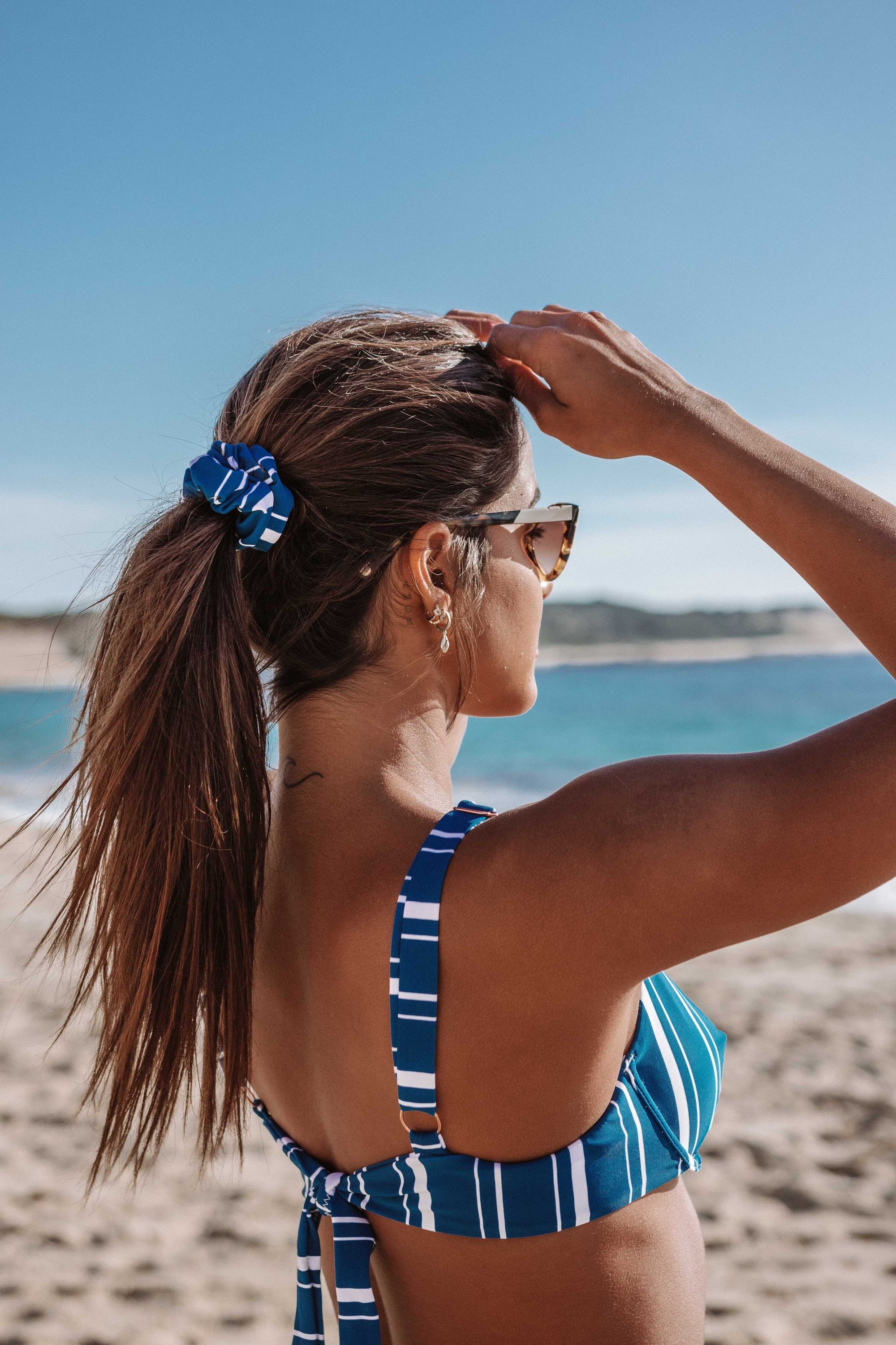 Navy Stripes Scrunchie Hair Tie made from soft swimwear fabric, featuring a stylish striped design perfect for summer.