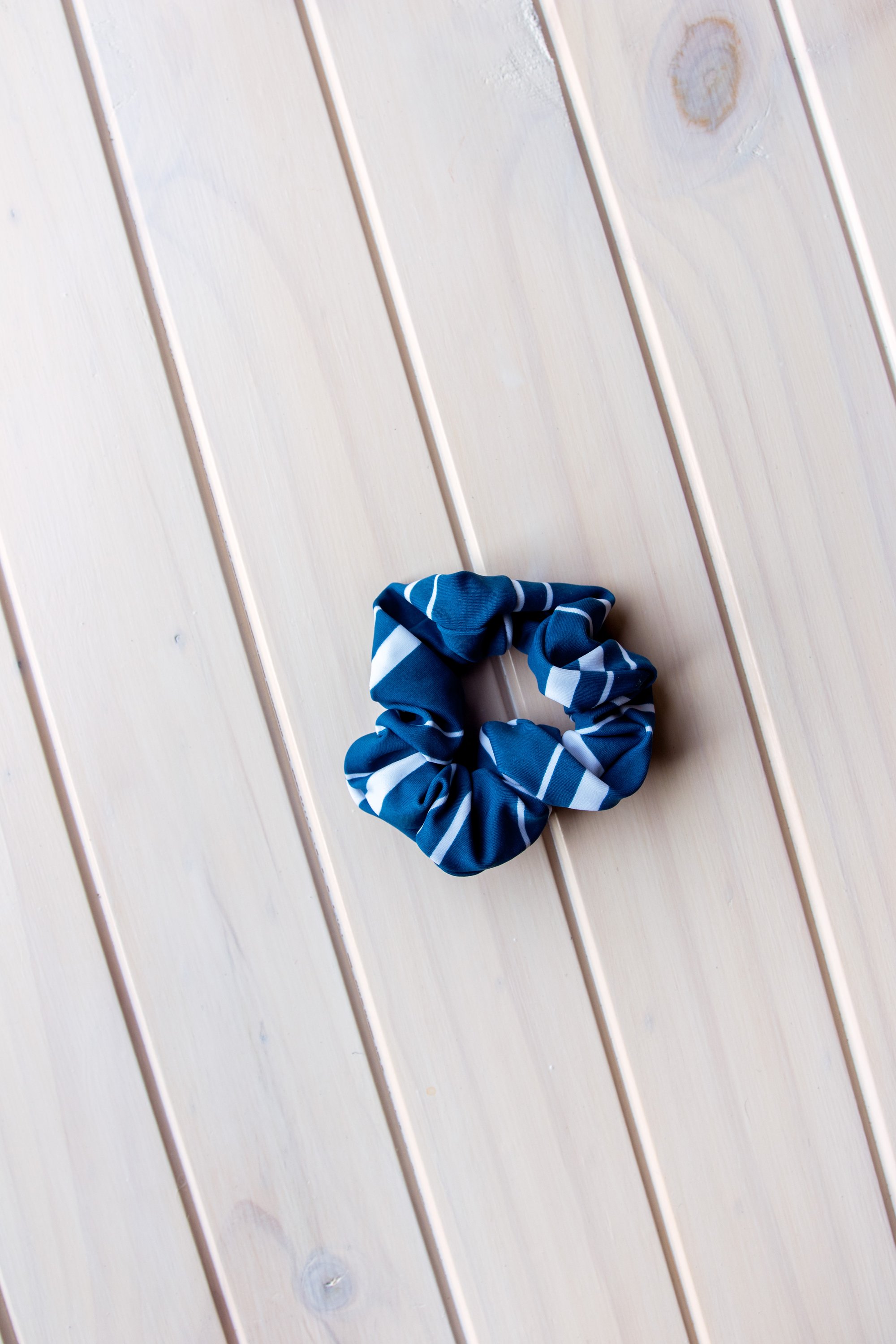 Navy Stripes Scrunchie Hair Tie made from soft swimwear fabric, featuring a stylish striped design perfect for summer.