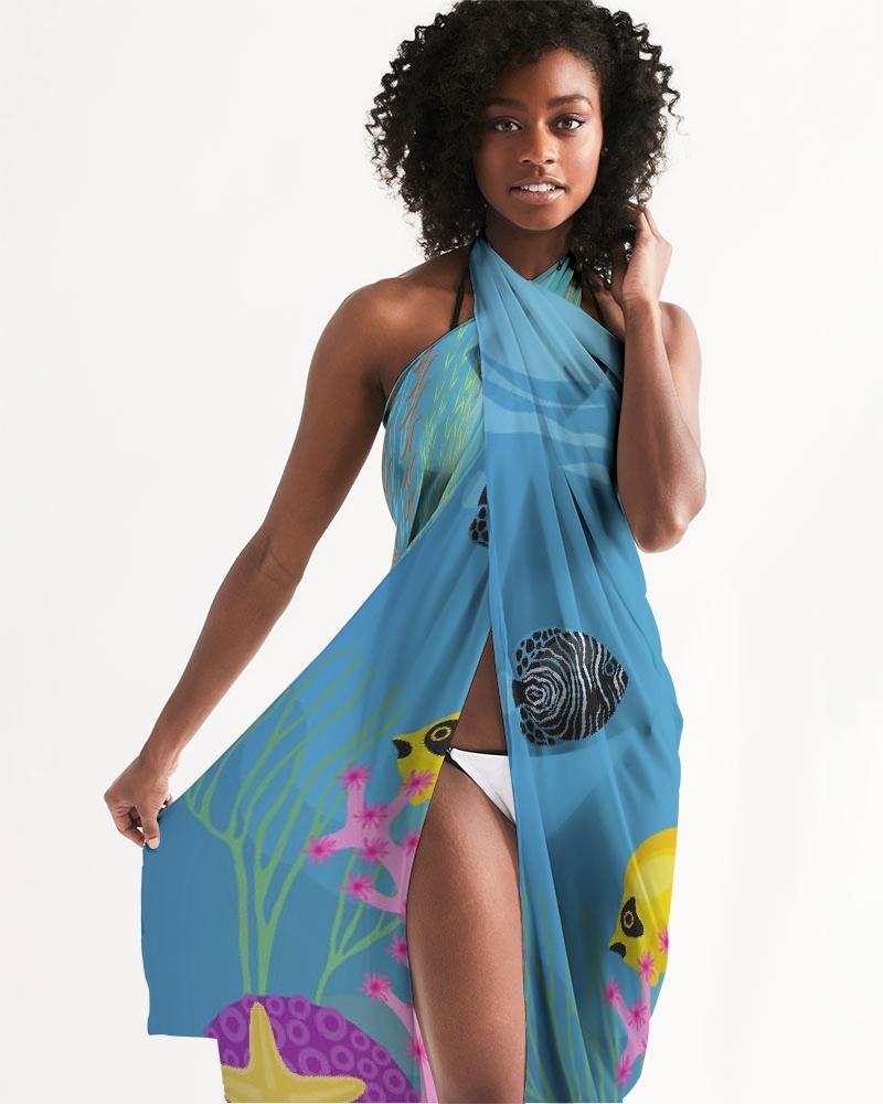 A stylish sheer aquatic blue swimsuit cover-up with a vibrant fish print, perfect for beach and poolside wear.