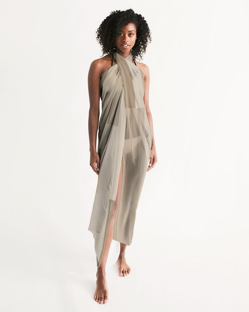 A stylish sheer beige swimsuit cover up with a flowy design, perfect for beach or poolside wear, featuring a self-tie closure.