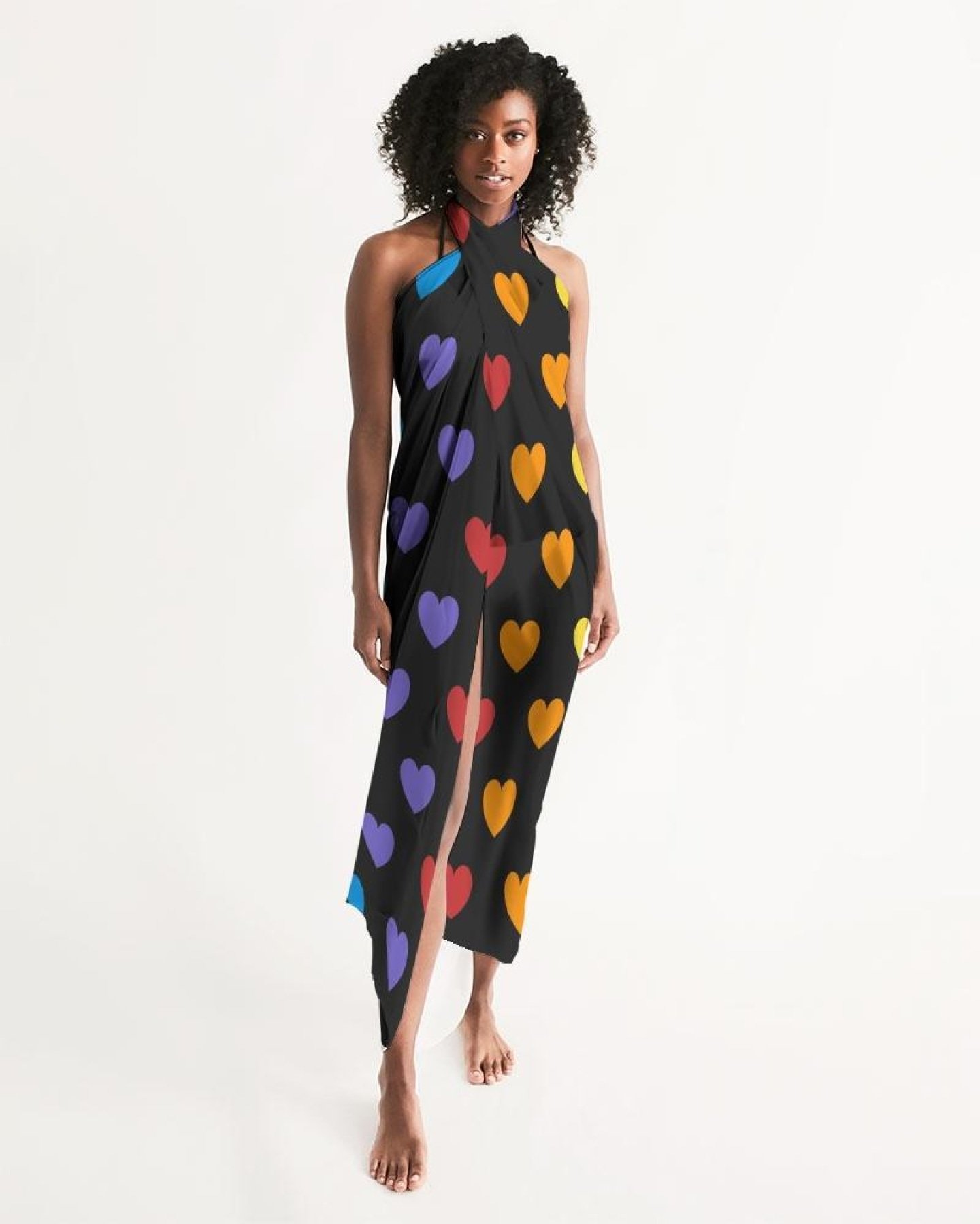 A vibrant Sheer Rainbow Heart Swimsuit Cover Up draped elegantly, showcasing its lightweight fabric and colorful heart design.