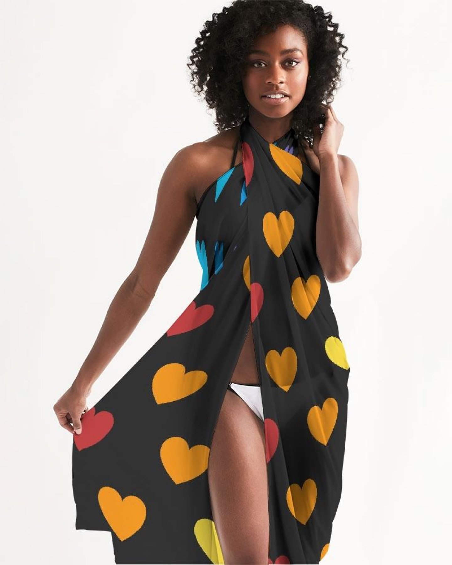 A vibrant Sheer Rainbow Heart Swimsuit Cover Up draped elegantly, showcasing its lightweight fabric and colorful heart design.