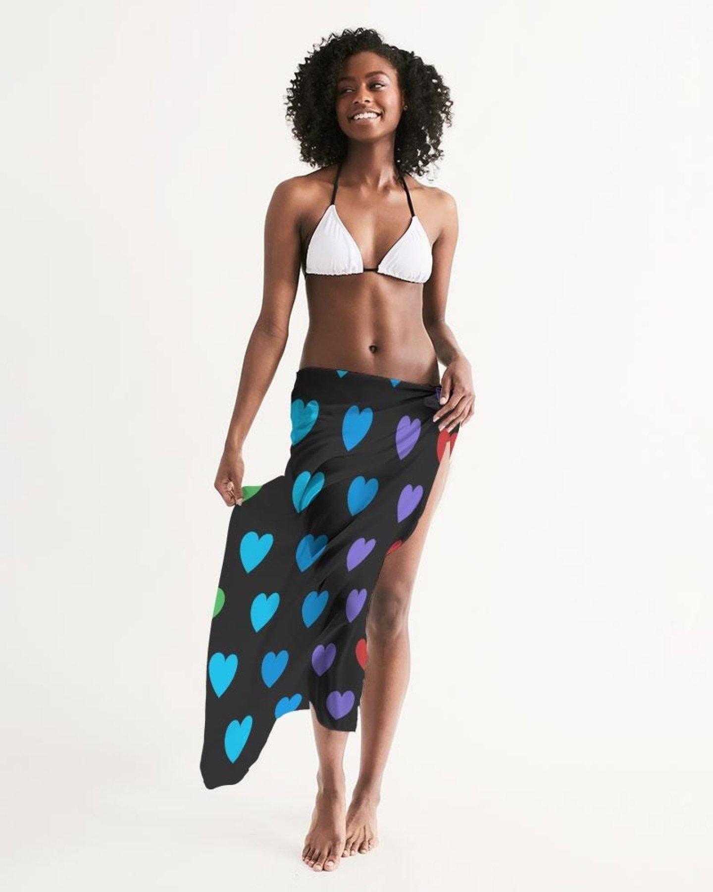 A vibrant Sheer Rainbow Heart Swimsuit Cover Up draped elegantly, showcasing its lightweight fabric and colorful heart design.