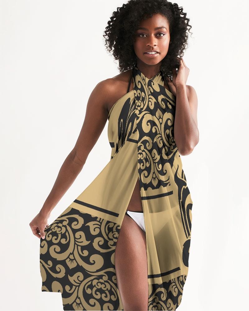 Sheer swimsuit cover up featuring an abstract black and gold print, perfect for beach or poolside wear.