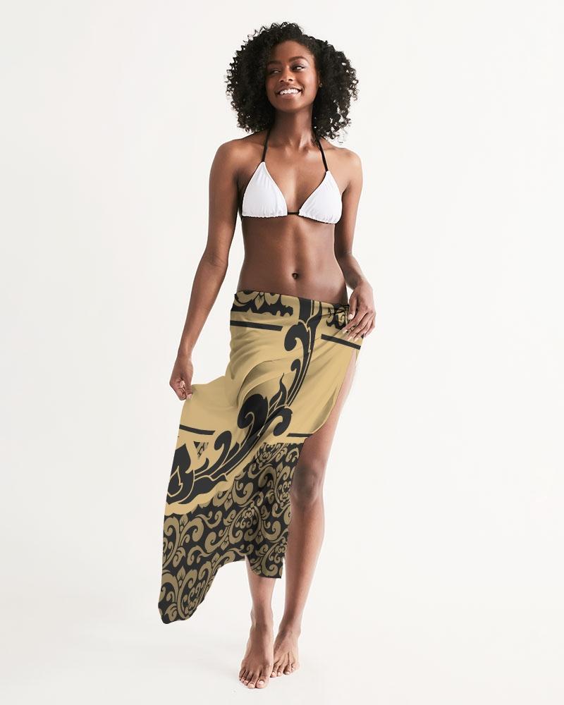 Sheer swimsuit cover up featuring an abstract black and gold print, perfect for beach or poolside wear.