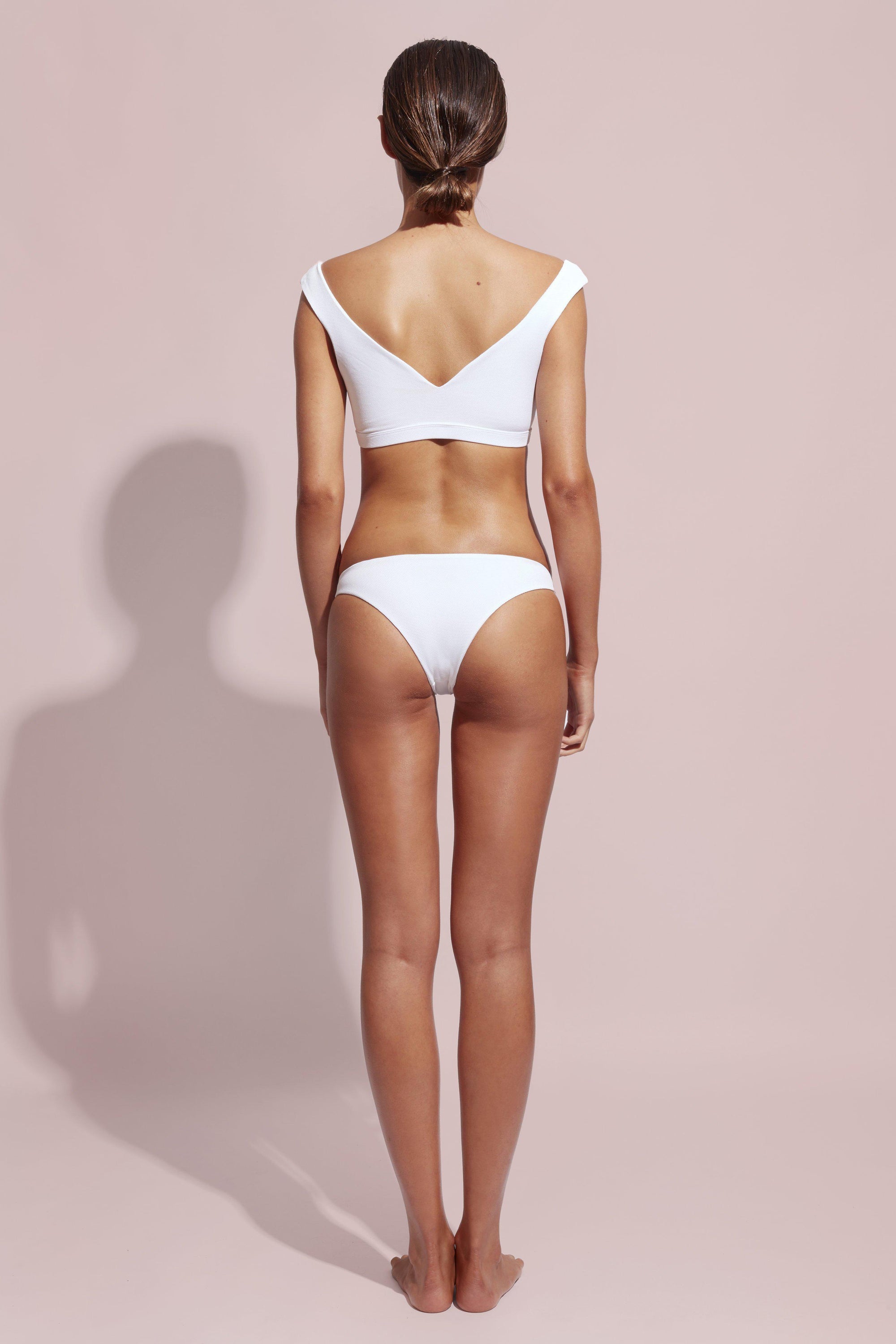 Wildaster Blake Bottom in Snow, a classic low rise bikini bottom with a moderate cheeky cut and seamless stitching, displayed on a white background.