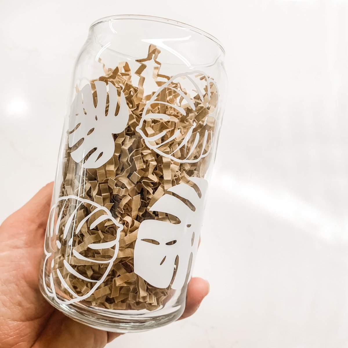 16 oz Beer Can Glass featuring Monstera Leaves design, showcasing a clear glass with a stylish vinyl print.