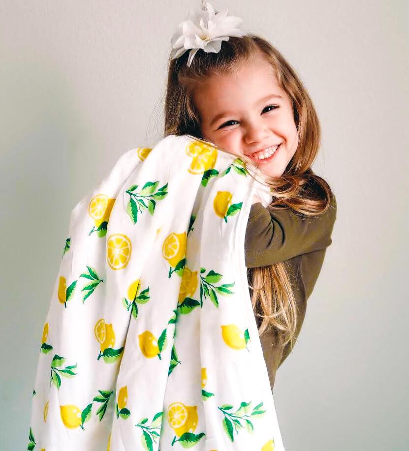 4 Layer Muslin Quilt with Lemon Print, showcasing its soft texture and vibrant design, perfect for babies and toddlers.