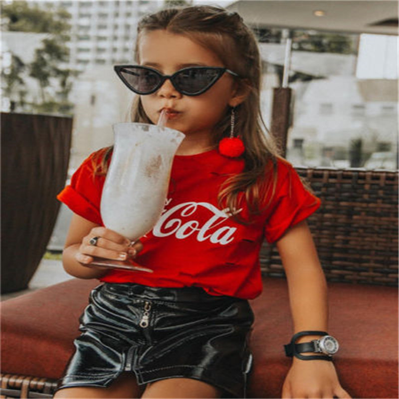 Child in sunglasses drinks milkshake.