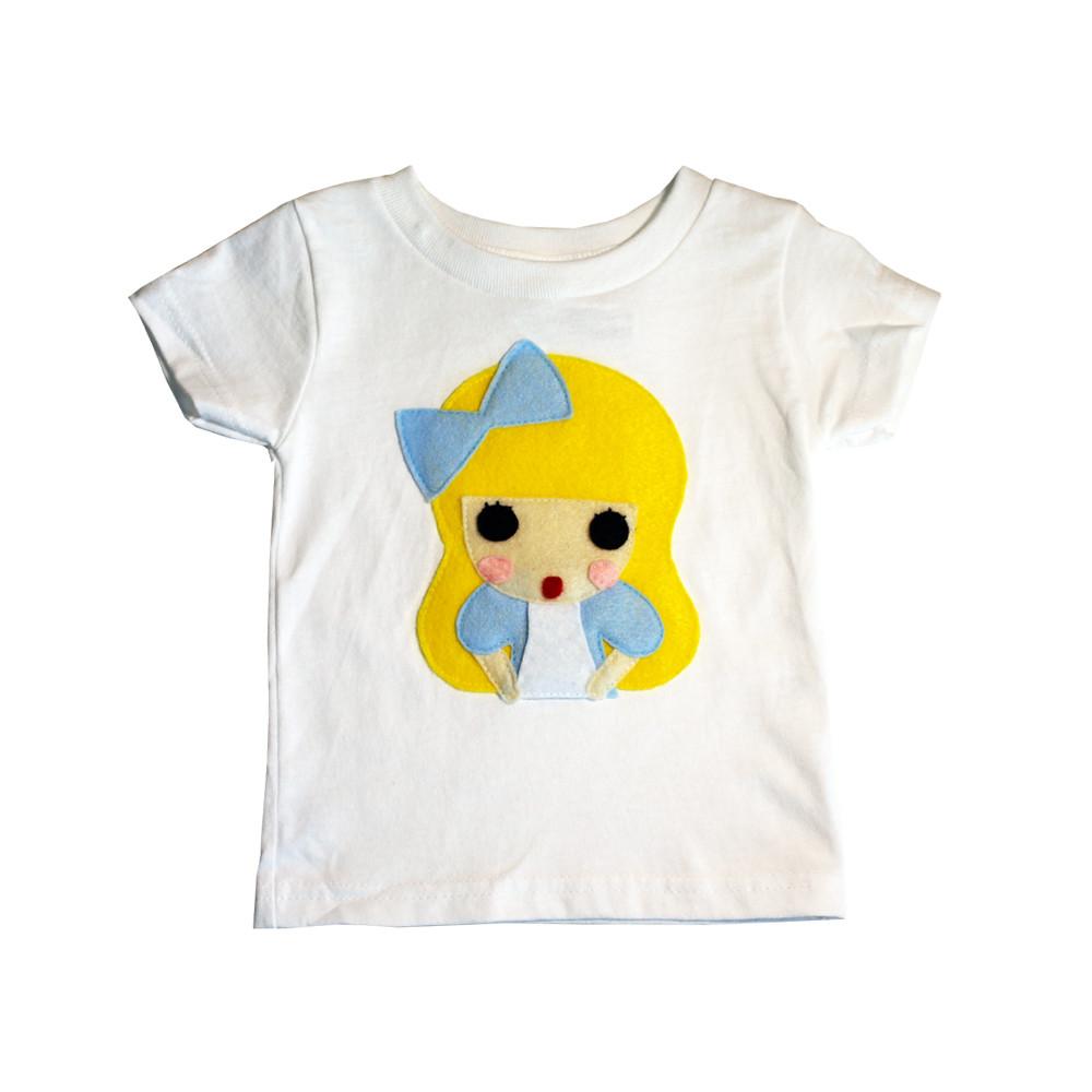 A colorful handmade kids t-shirt featuring an appliqué design of Alice from Alice's Adventures in Wonderland, crafted with eco-friendly materials.