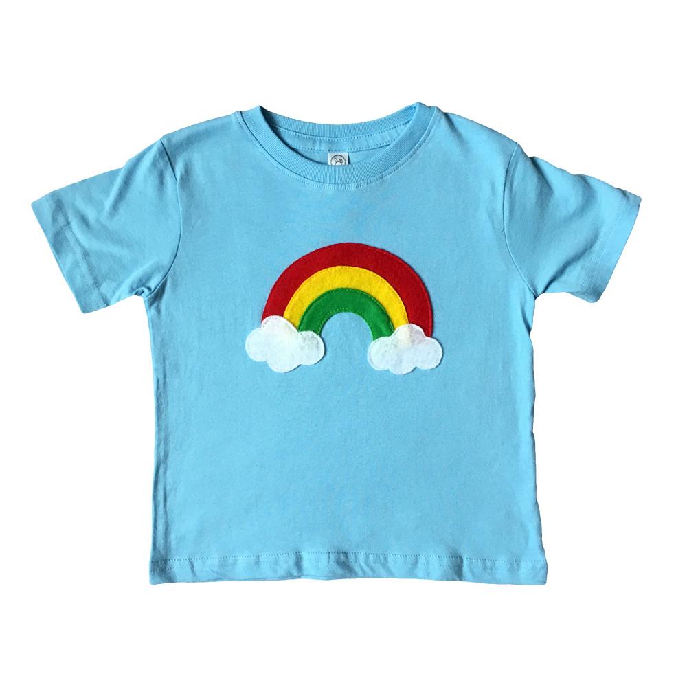 Aloha Rainbow Kids Baby Blue Shirt featuring a colorful rainbow design on a soft blue background, perfect for boys and girls.