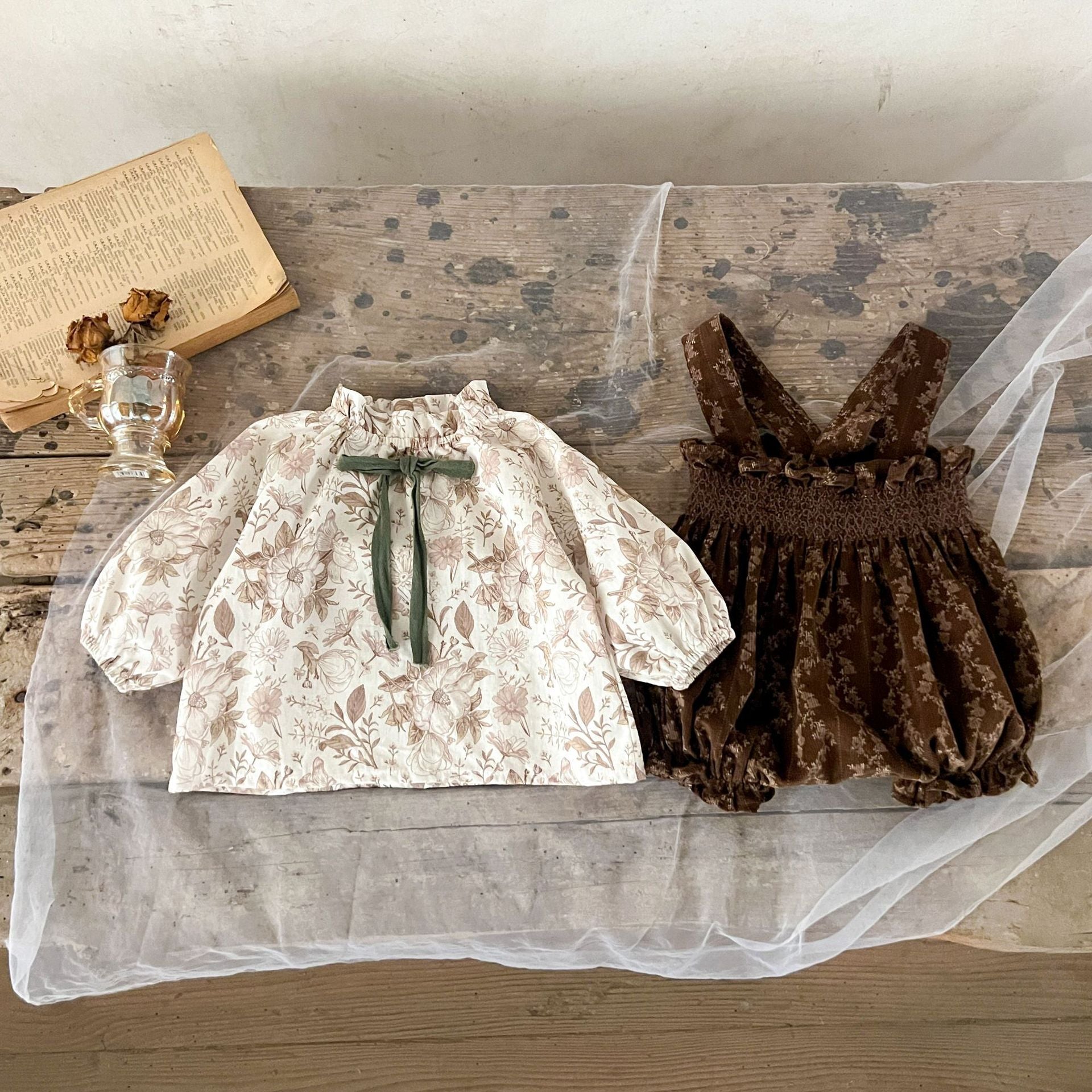 A beige and brown floral vine print long sleeves top for baby girls with a bow-tied detail, perfect for autumn wear.