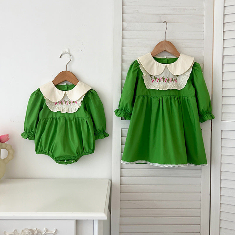 A stylish Arrival Autumn Baby Kids Girls dress featuring long sleeves and a Peter Pan collar in green and beige colors, adorned with an embroidered pattern.