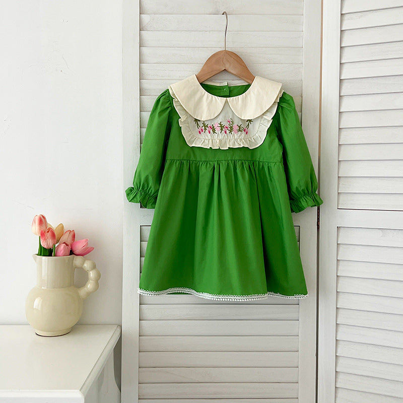 A stylish Arrival Autumn Baby Kids Girls dress featuring long sleeves and a Peter Pan collar in green and beige colors, adorned with an embroidered pattern.