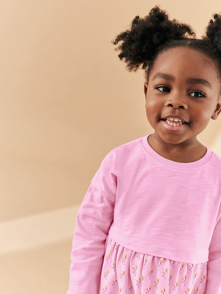 A pink long sleeve top featuring a cartoon princess mouse design, perfect for girls aged 12 months to 10 years.