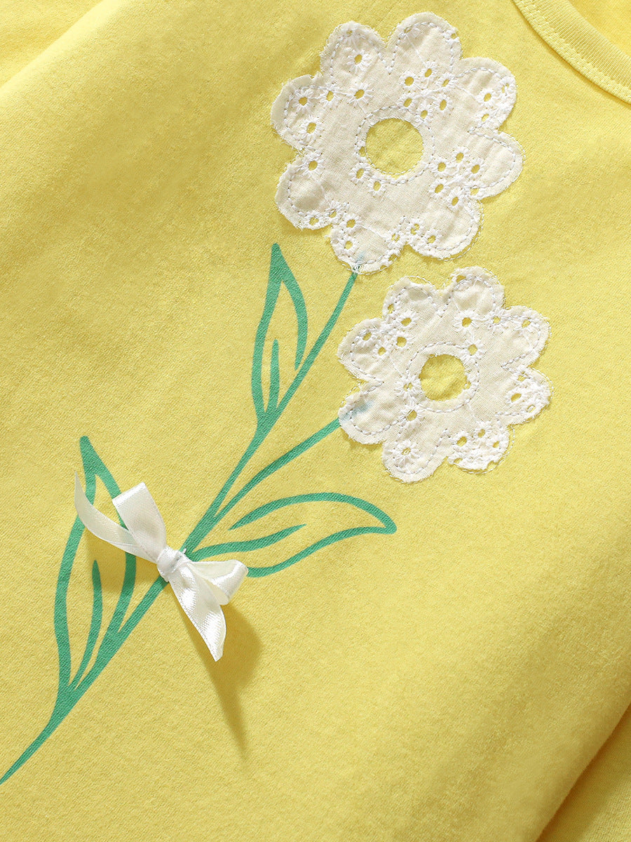 A vibrant yellow long-sleeved t-shirt for girls featuring a cute floral pattern, made from soft cotton, perfect for spring and autumn wear.