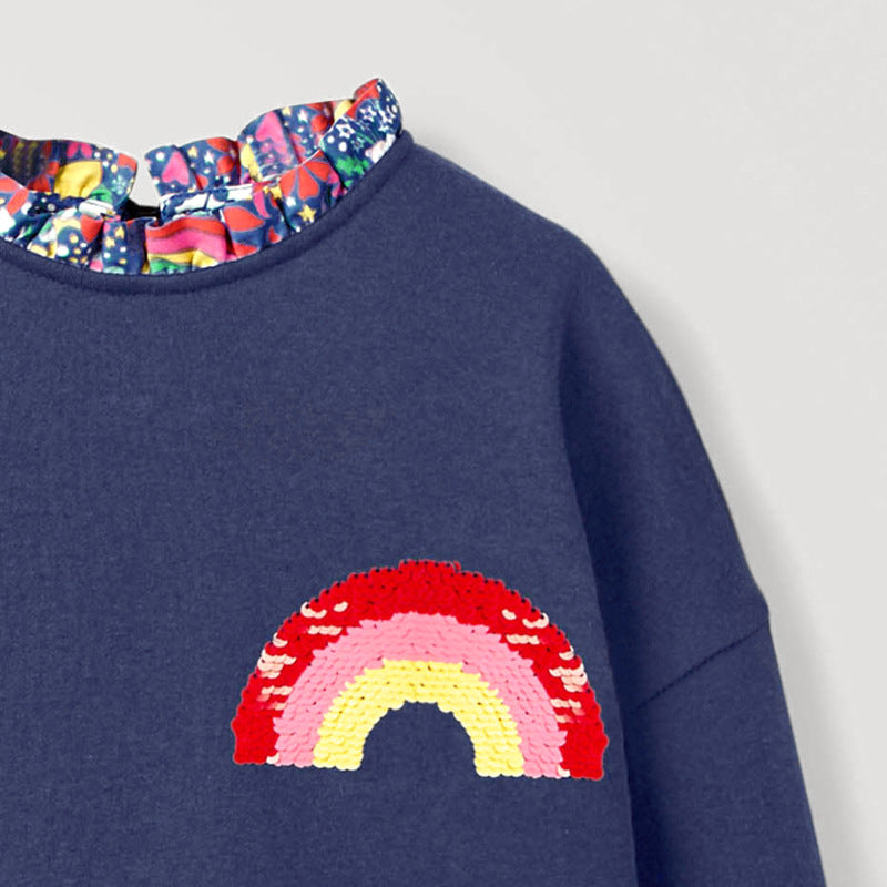 A vibrant black and blue sweatshirt featuring rainbow embroidery, designed for girls aged 12 months to 10 years.