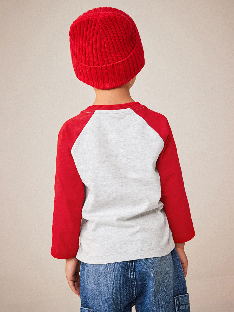 A vibrant red long-sleeve shirt for kids featuring a playful cartoon pattern, perfect for Christmas celebrations.