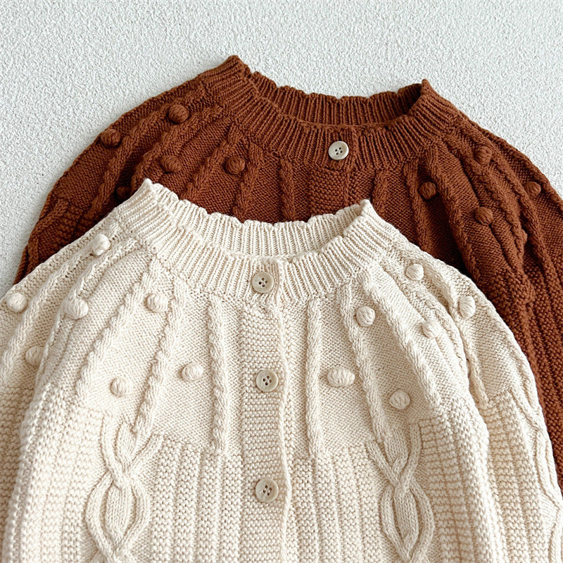 A beige and coffee long-sleeved cardigan for baby girls featuring a playful hairball design, made from soft cotton material.