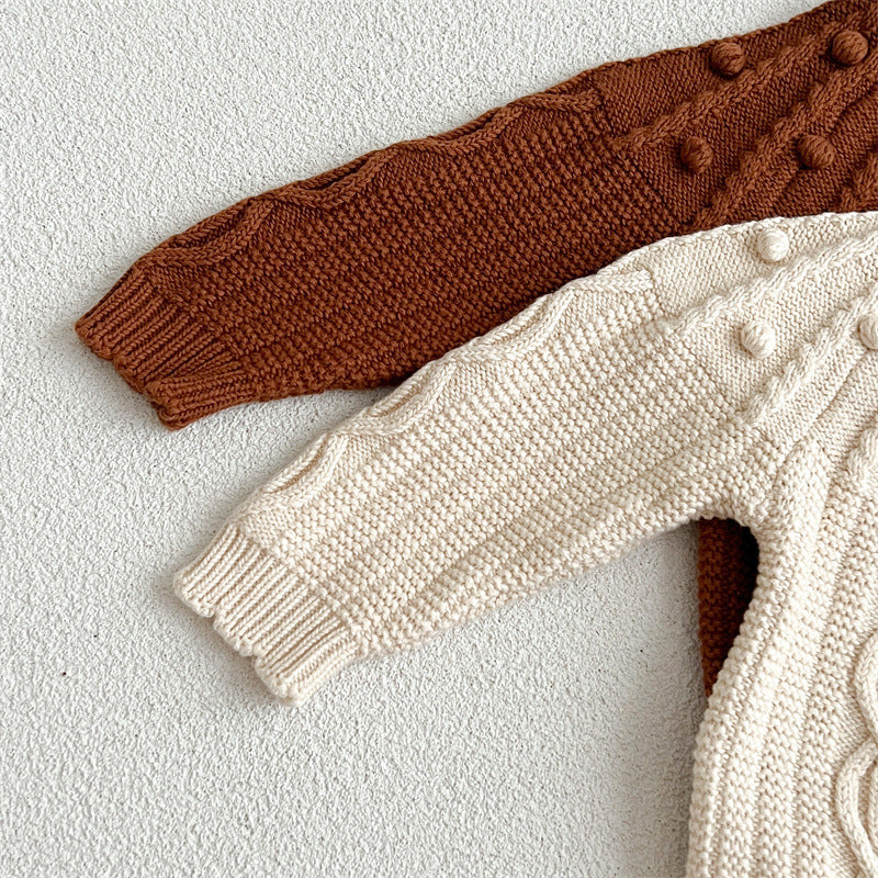 A beige and coffee long-sleeved cardigan for baby girls featuring a playful hairball design, made from soft cotton material.