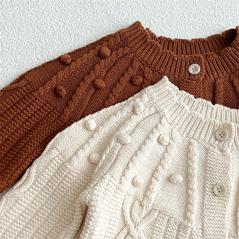 A beige and coffee long-sleeved cardigan for baby girls featuring a playful hairball design, made from soft cotton material.