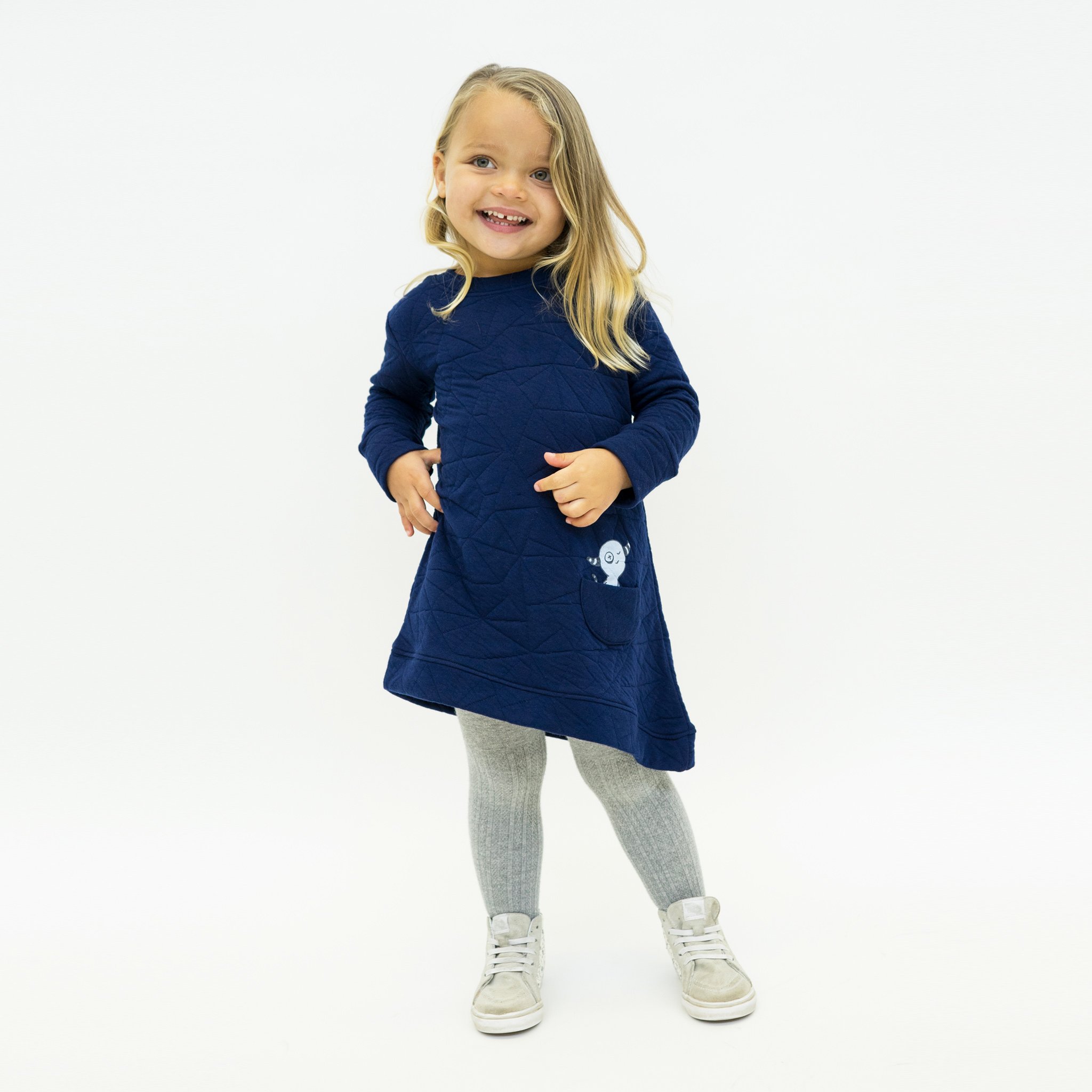 Asymmetric dress in quilted deep blue with a unique design, featuring a monster peek-a-boo pocket and thumbholes for toddlers.