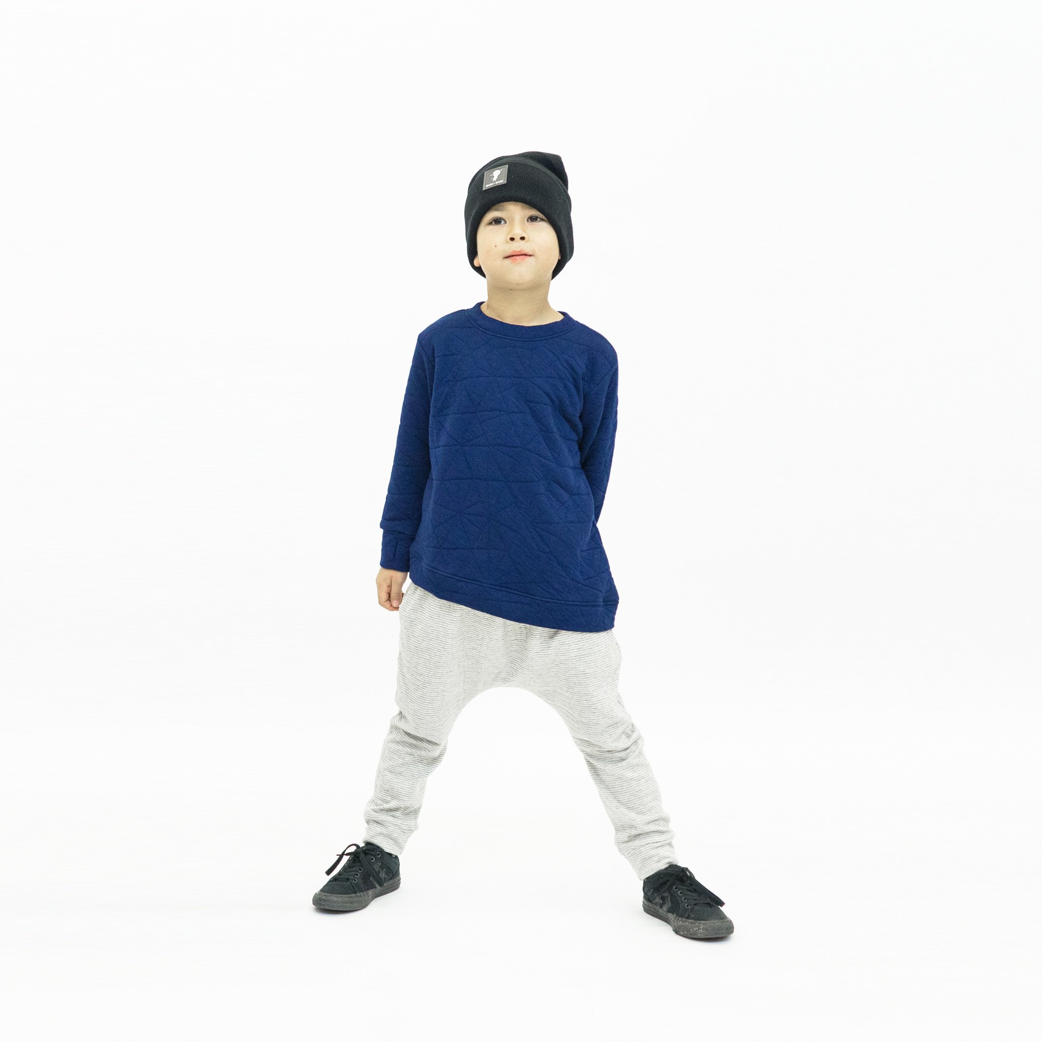 Youth Asymmetric Pullover in Quilted Deep Blue with hidden monster pocket and thumbholes, showcasing its unique design and soft fabric.