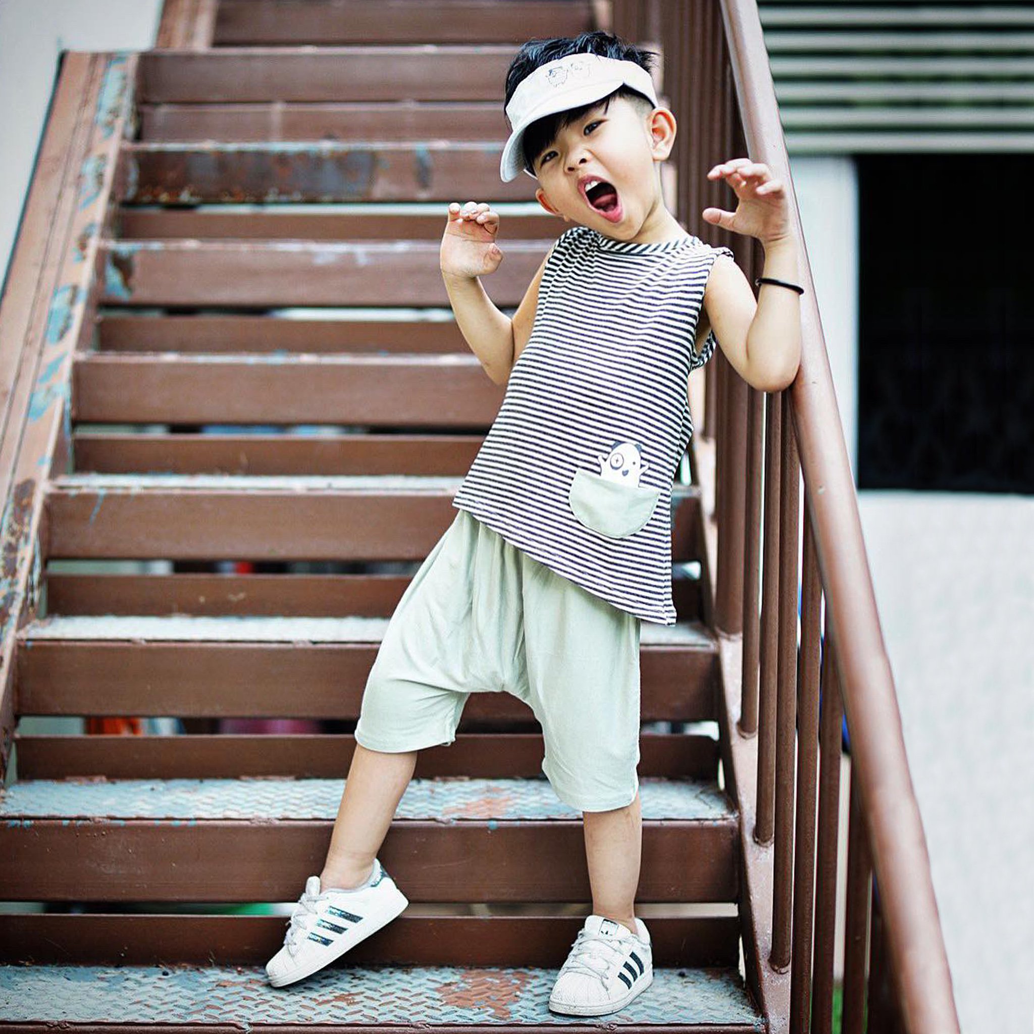 Asymmetric Tank in Black and White Stripes featuring a unique hem and monster pocket.