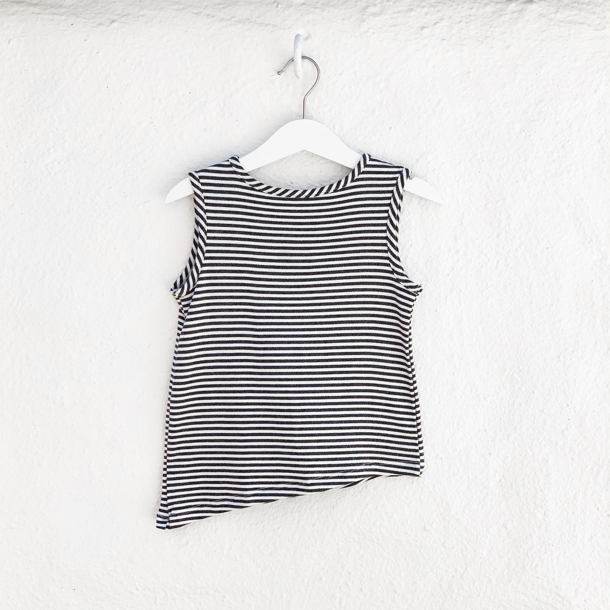 Asymmetric Tank in Black and White Stripes featuring a unique hem and monster pocket.