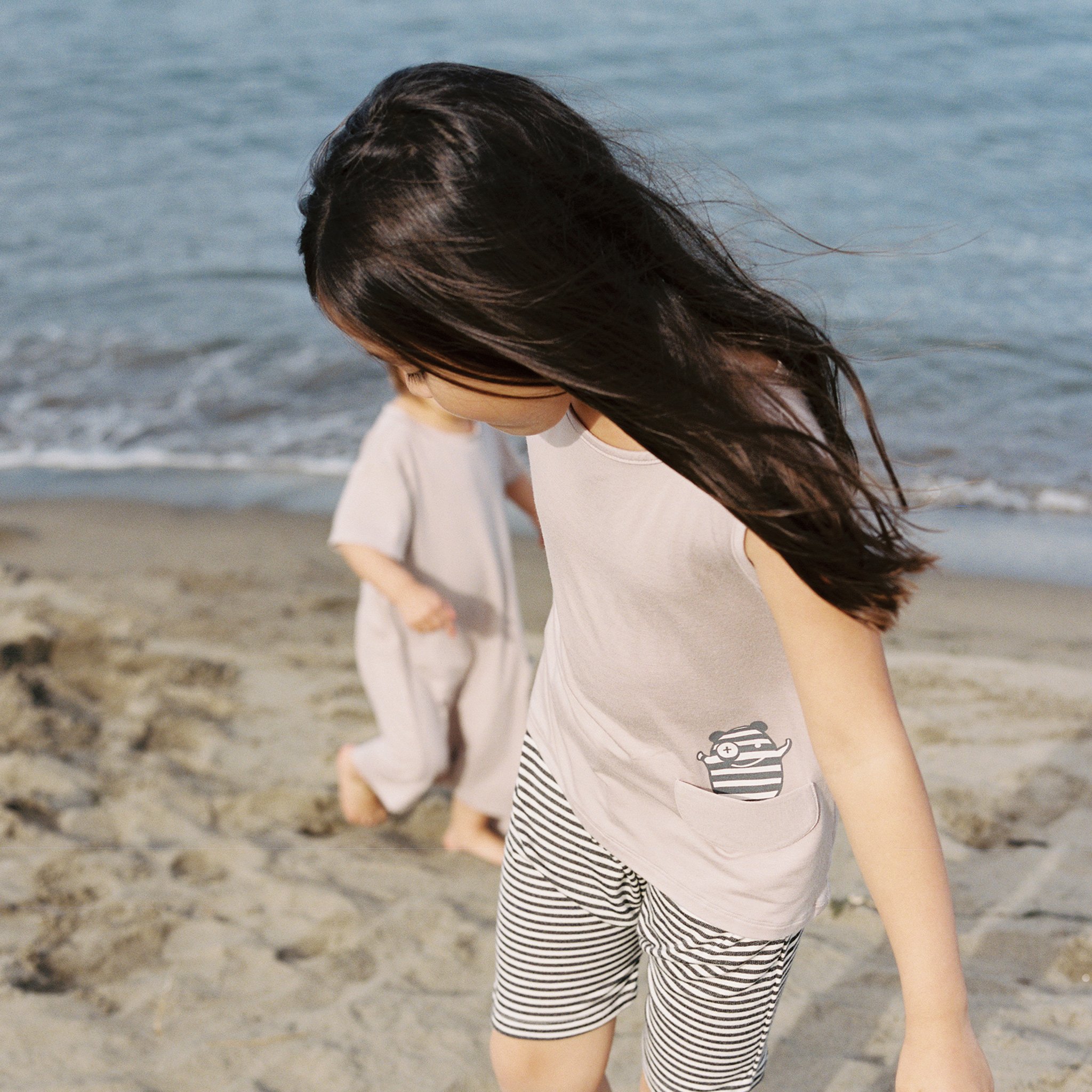 Asymmetric Tank in Mocha featuring a unique hem and monster pocket, made from soft rayon modal fabric.