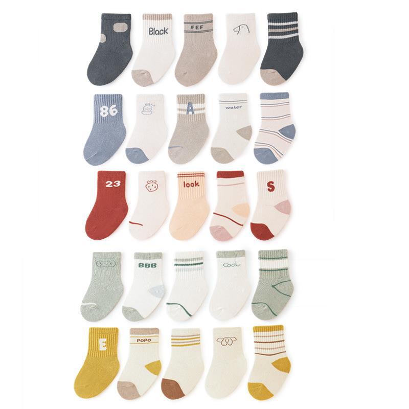 A collection of colorful baby socks featuring cartoon prints in pink, blue, green, yellow, and grey, suitable for both boys and girls.