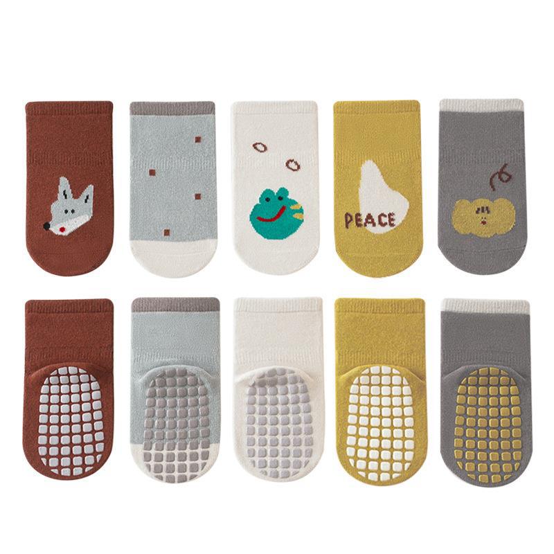 A pair of colorful autumn cartoon print socks for kids, featuring playful designs in white, blue, yellow, grey, and brown.