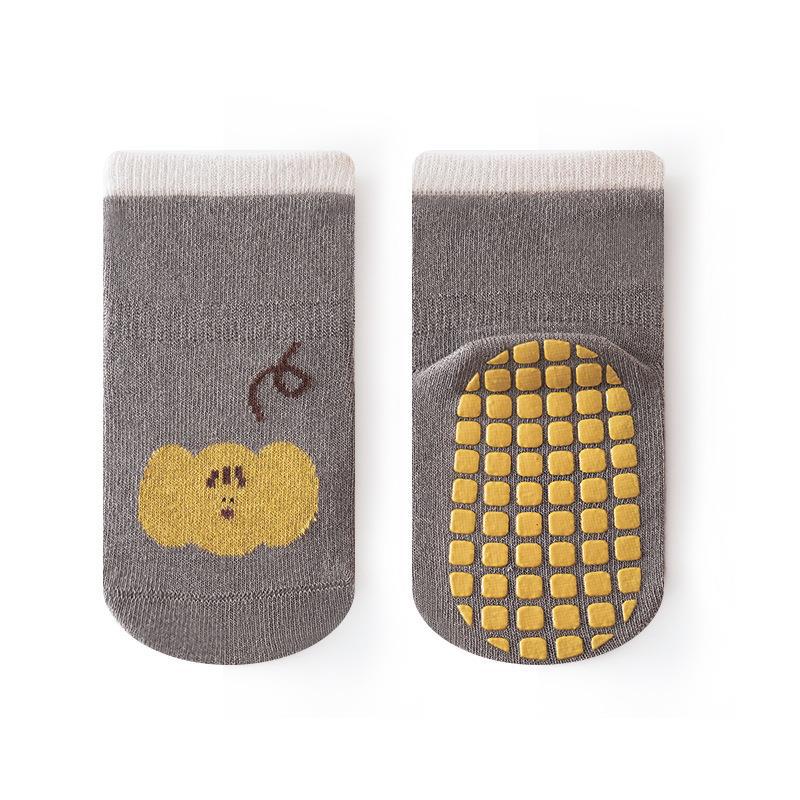 A pair of colorful autumn cartoon print socks for kids, featuring playful designs in white, blue, yellow, grey, and brown.