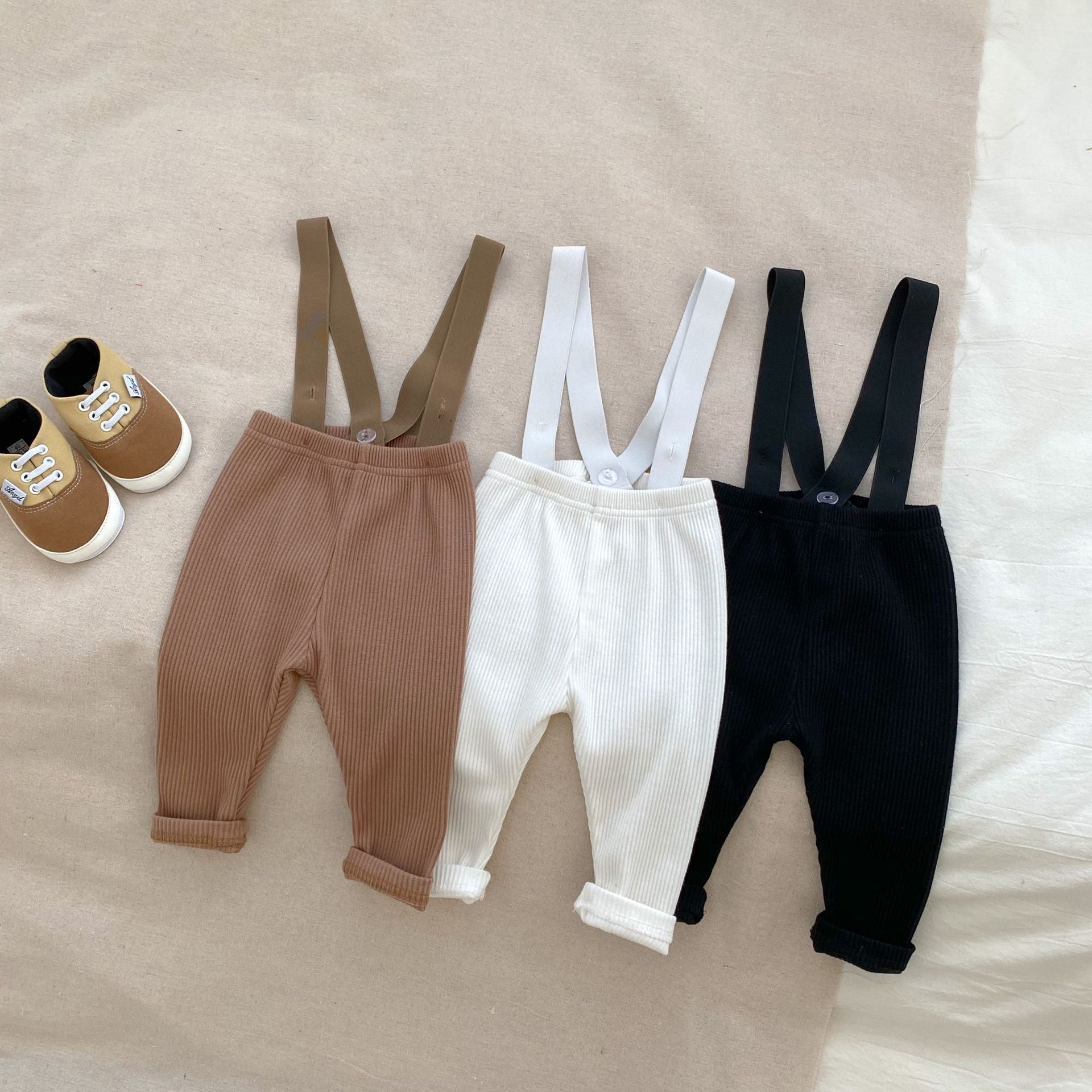 A stylish Autumn Casual Solid Color Long Sleeve Set for babies, featuring a soft cotton fabric in white, black, and coffee colors.