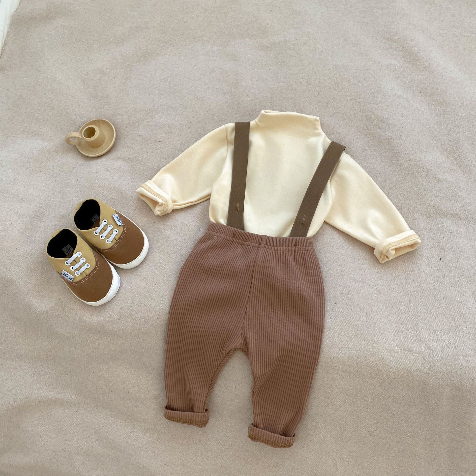 A stylish Autumn Casual Solid Color Long Sleeve Set for babies, featuring a soft cotton fabric in white, black, and coffee colors.