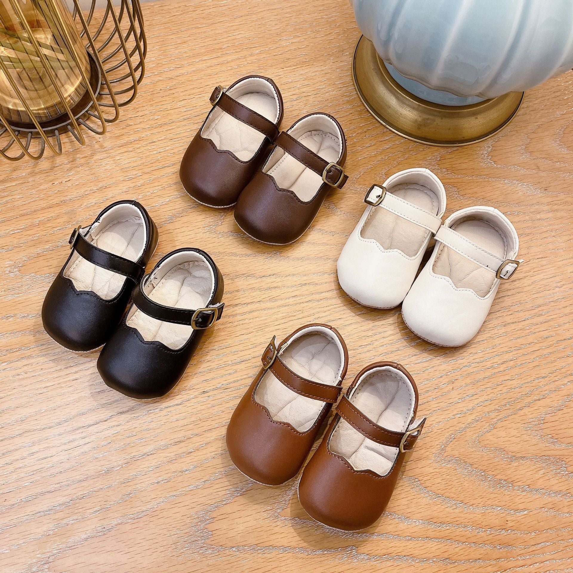 Autumn Fashion Baby Girl Solid Color Leather Toddler Shoes in white, black, khaki, and brown, showcasing their stylish design and quality material.